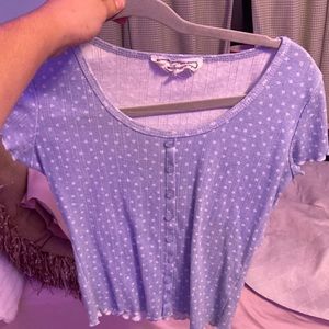 A light blue shirt with buttons and flower pattern